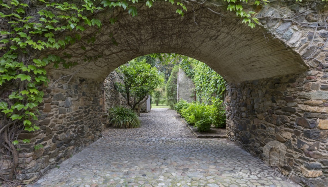 View of the round arch leading to the interior garden from the courtyard