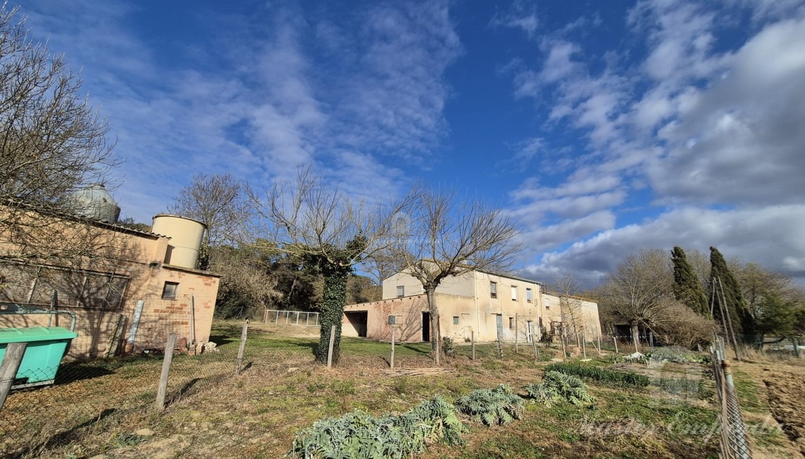 Side view of the farmhouse and stables
