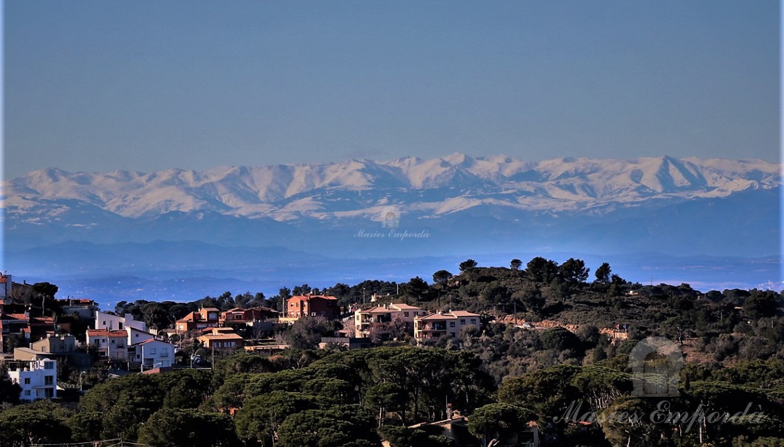 View of the parcel of Begur and the Pyrenees at the bottom of the image