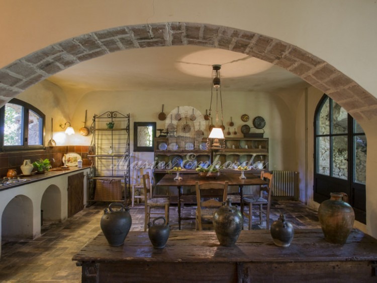 Detail of the kitchen dining room of the guest house of the property attached to the main farmhouse with loading stone arch of the second floor.