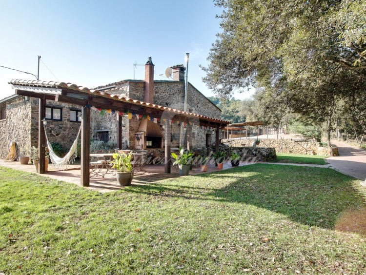 View of the side façade and porch of the farmhouse